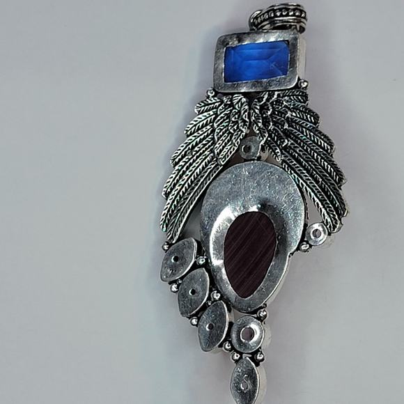 Sterling Silver Pendant with Brown Carved Face, Blue Topaz, and Feather Motif - Picture 6 of 13